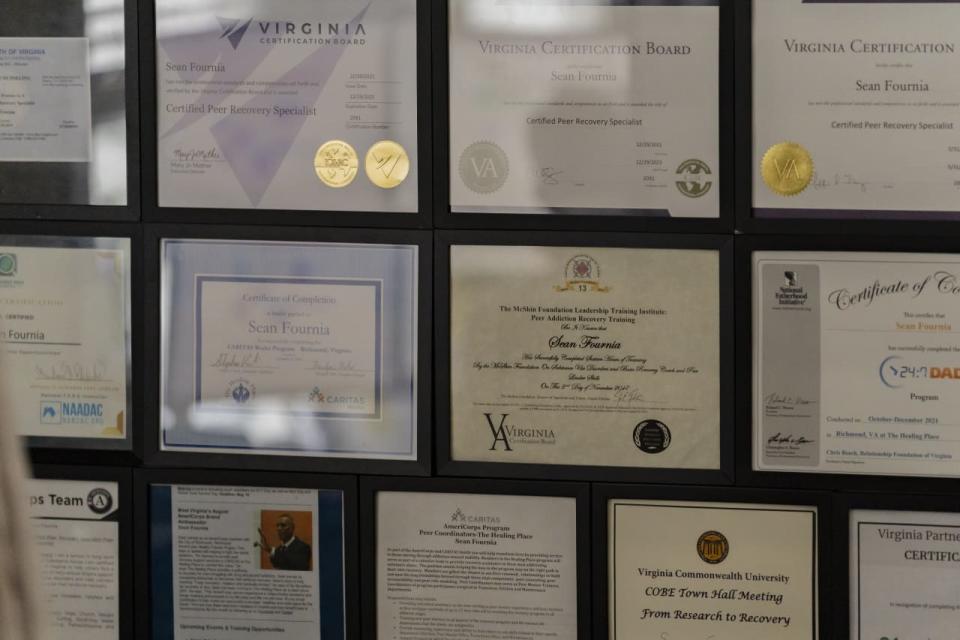 Degrees and certificates hang on the wall of Fournia's Virginia home. 