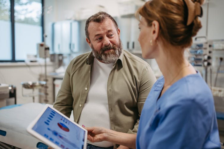 The doctor talks to the patient