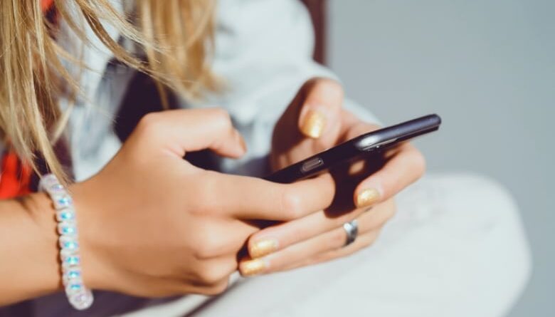 Stock photo of a woman using a smartphone.