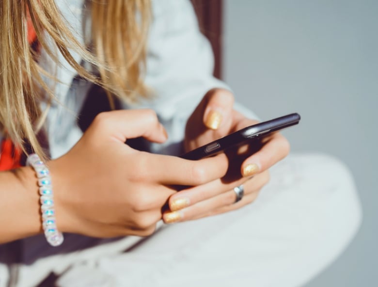 Stock photo of a woman using a smartphone.